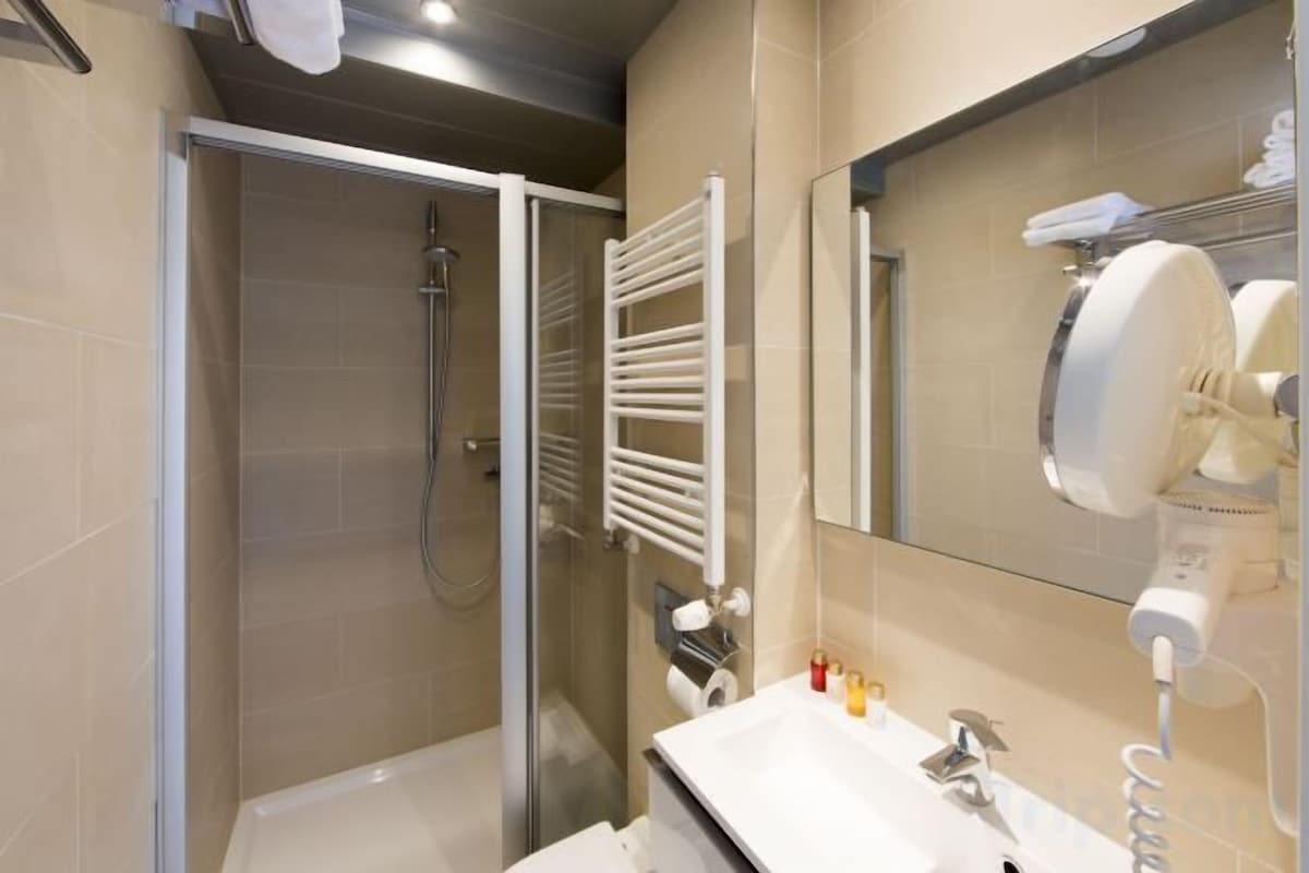 Shower, designer toiletries, hair dryer, towels