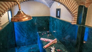 A bathroom with a blue marble floor, a towel, and a bottle of lotion. - Medina Loft & Spa (Marrakech)
