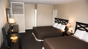 A hotel room with two beds, a desk, and a chair. - Travel Inn (Laramie)
