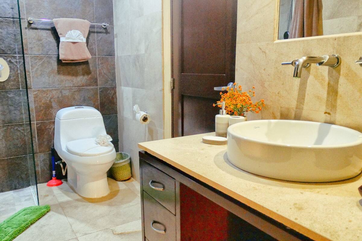 family apartment with jacuzzi and garden view | bathroom | shower, rainfall showerhead, towels, soap