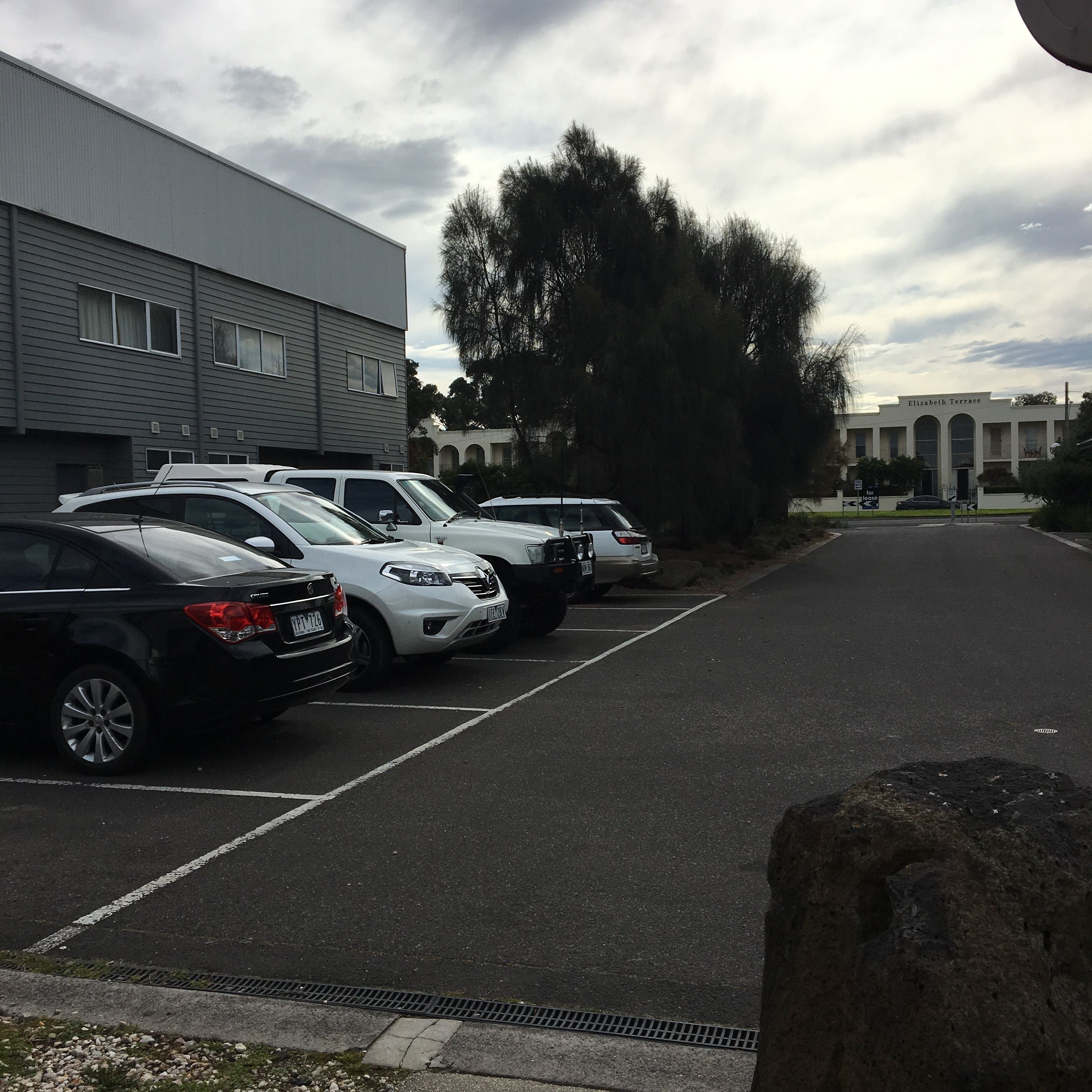 A parking lot with several cars parked in front of a building labeled "Elizabeth Terrace."