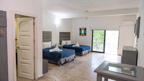 A hotel room with two beds, a balcony with a view, a TV, and a desk. - Hotel Splash Inn Nuevo Vallarta (Nuevo Nayarit)