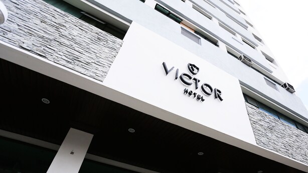 A hotel sign with the name "VICTOR HOTEL" prominently displayed. - The Victor Hotel (Makati)