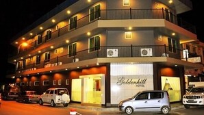 A multi-story hotel with balconies and air conditioning units, featuring a prominent "Goldenhill Hotel" sign. - Goldenhill Hotel (Kota Kinabalu)