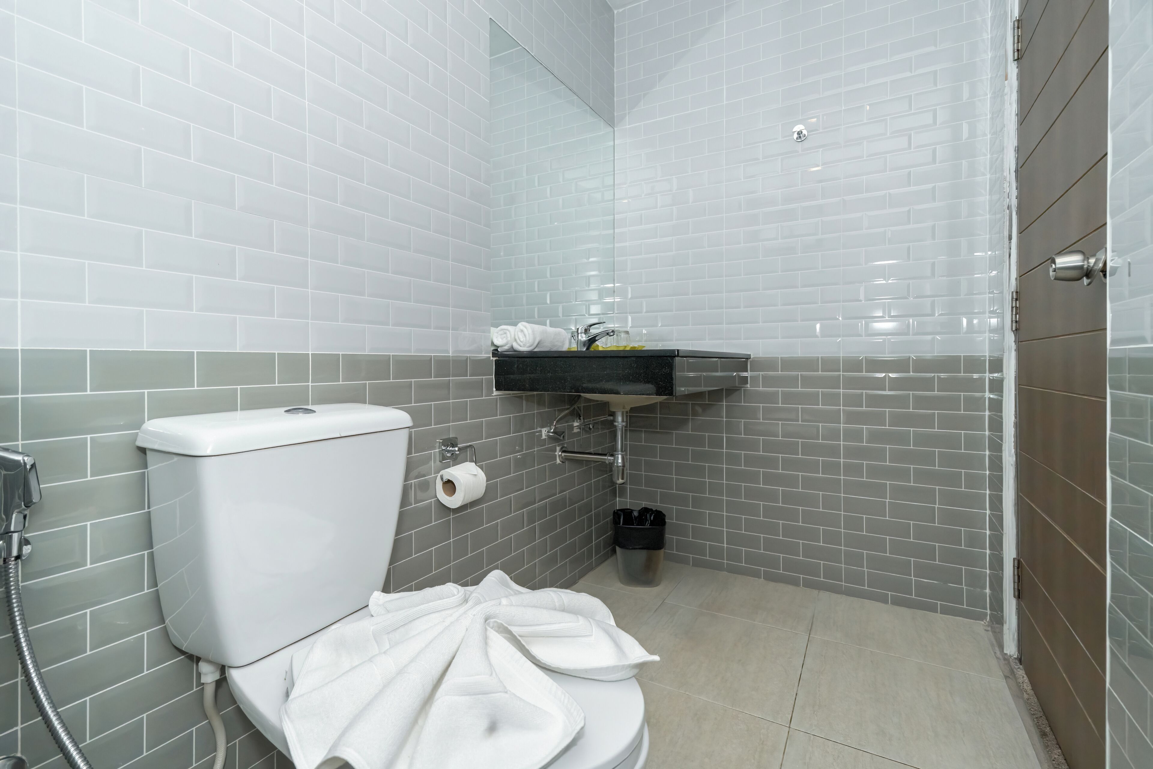 A bathroom with a toilet, sink, and shower area.