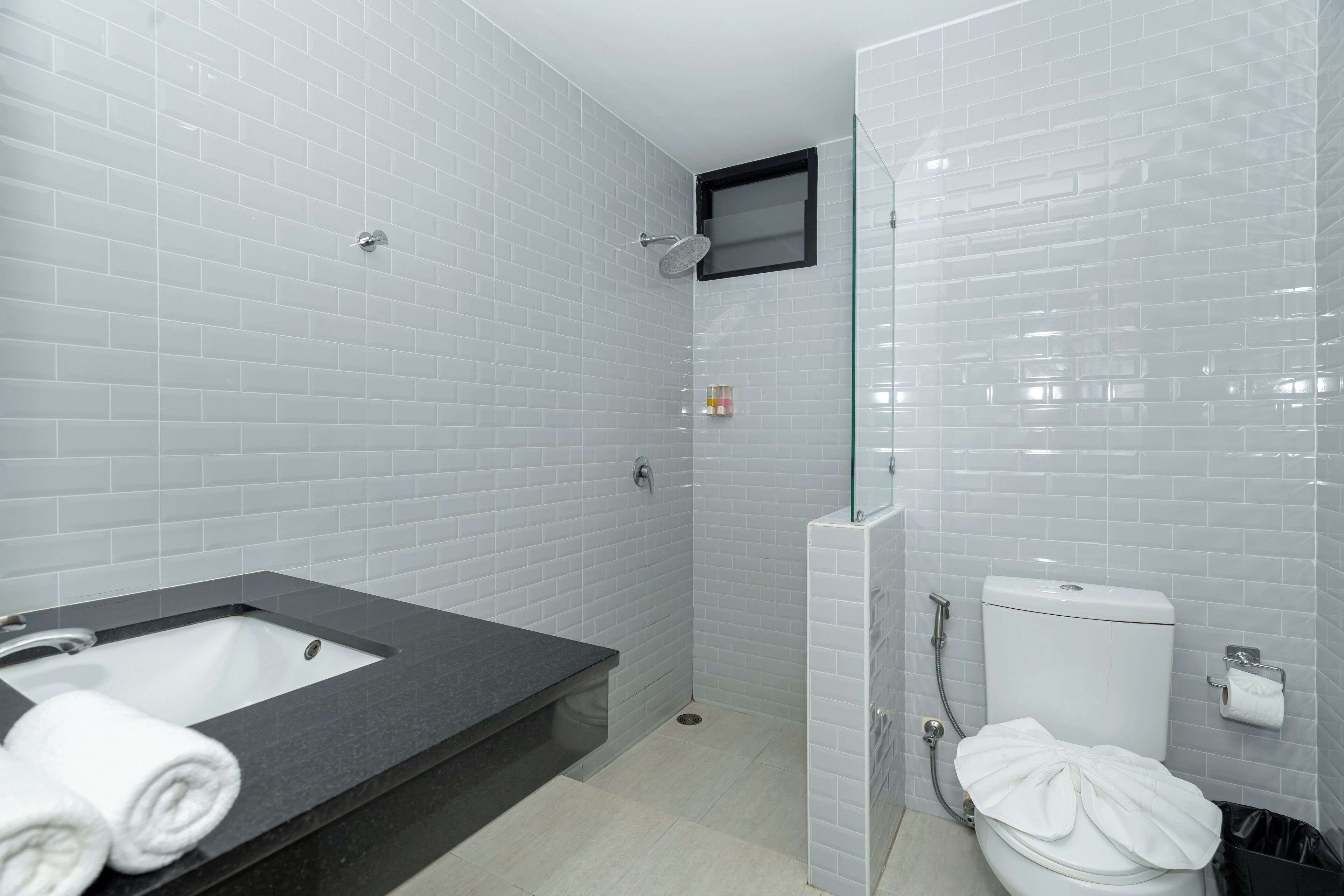 A bathroom with a bathtub, toilet, and shower.