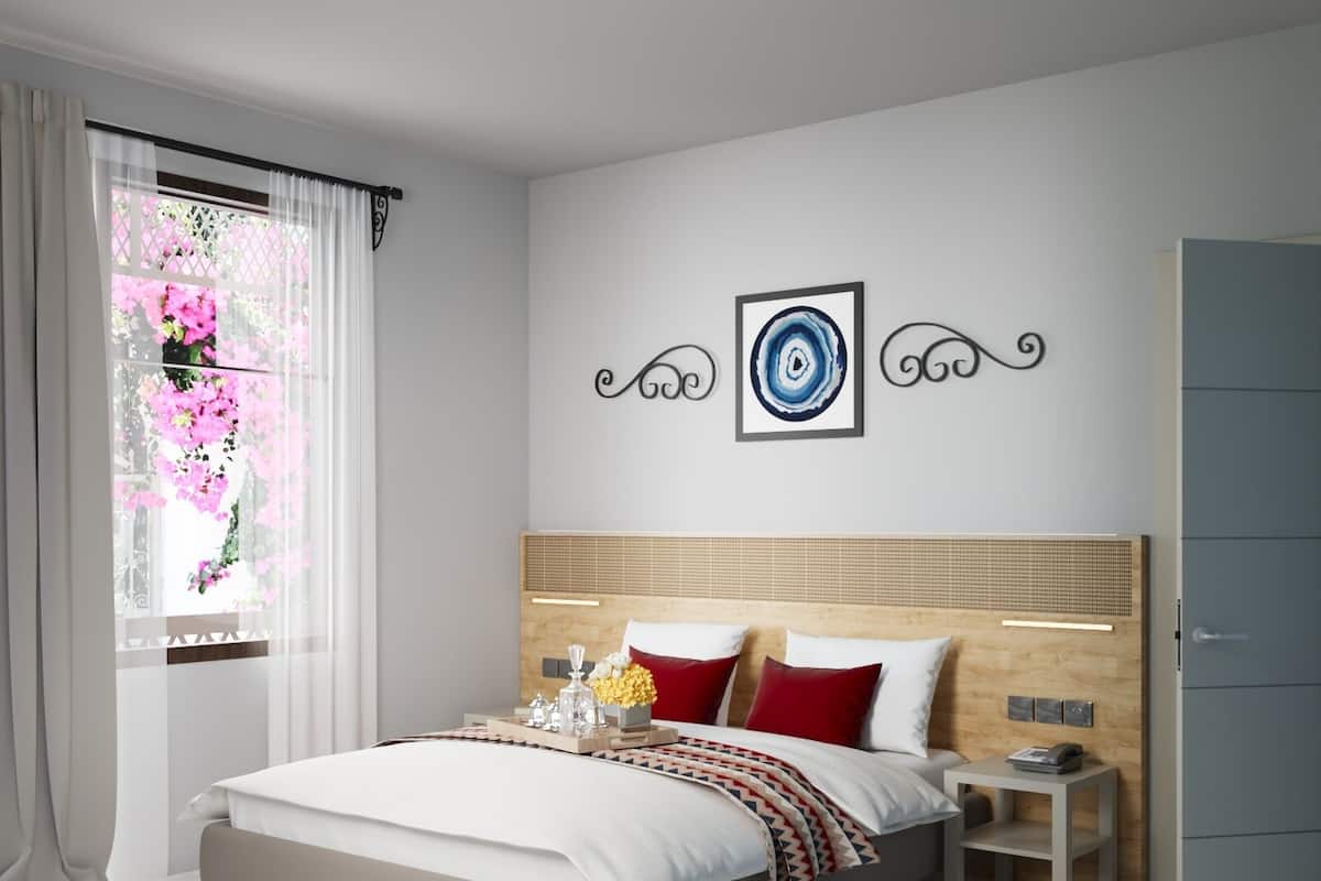 A modern bedroom with a large bed, a bedside table, a wardrobe, and a window with curtains.