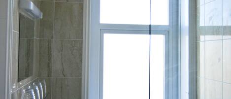 A bathroom with a window, a sink, and a toilet.