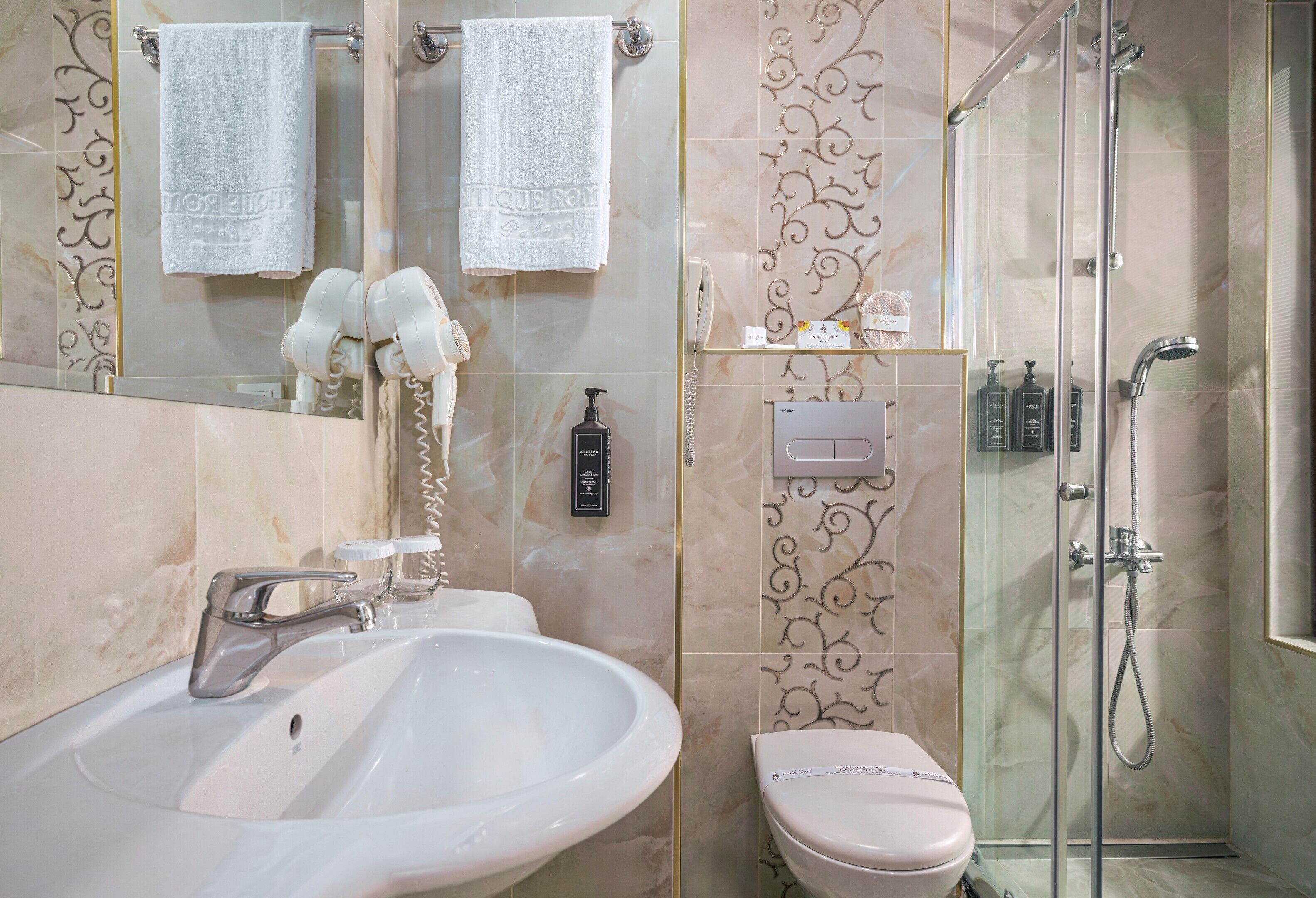 Een badkamer met een wastafel, toilet en een douchecabine.