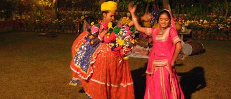 Two people in traditional attire performing a dance.