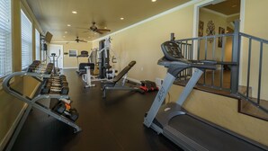 A home gym with treadmills, dumbbells, and weight machines. - Club Naples RV Resort (Naples)