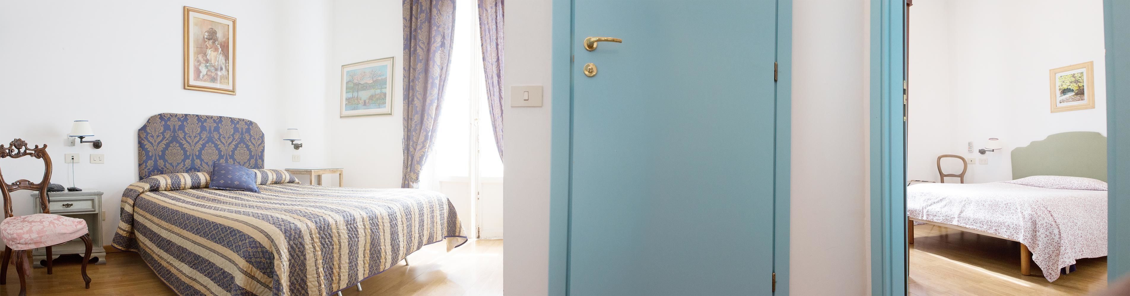 A room with a bed, a chair, a desk, and a door.