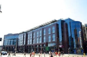 A modern building with a glass facade and a flat roof.