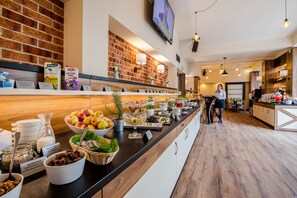 A buffet area with a variety of food items and beverages, including fruits, salads, and dairy products. - Park Hotel Diament Zabrze (Zabrze)