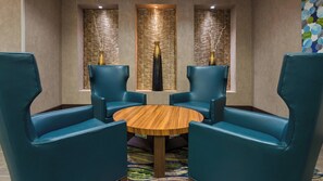 A room with a round wooden table surrounded by four blue chairs, two on each side. - Holiday Inn Express & Suites Midland South I-20 by IHG (Midland)