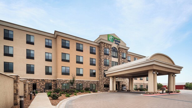 A large hotel with a prominent sign for Hampton Inn Express & Suites. It features a modern design with a central courtyard and a covered entrance area. - Holiday Inn Express & Suites Midland South I-20 by IHG (Midland)