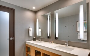 A modern bathroom with two sinks, a large mirror, and a wooden vanity. - Hyatt Place at Anaheim Resort/Convention Center (Anaheim)