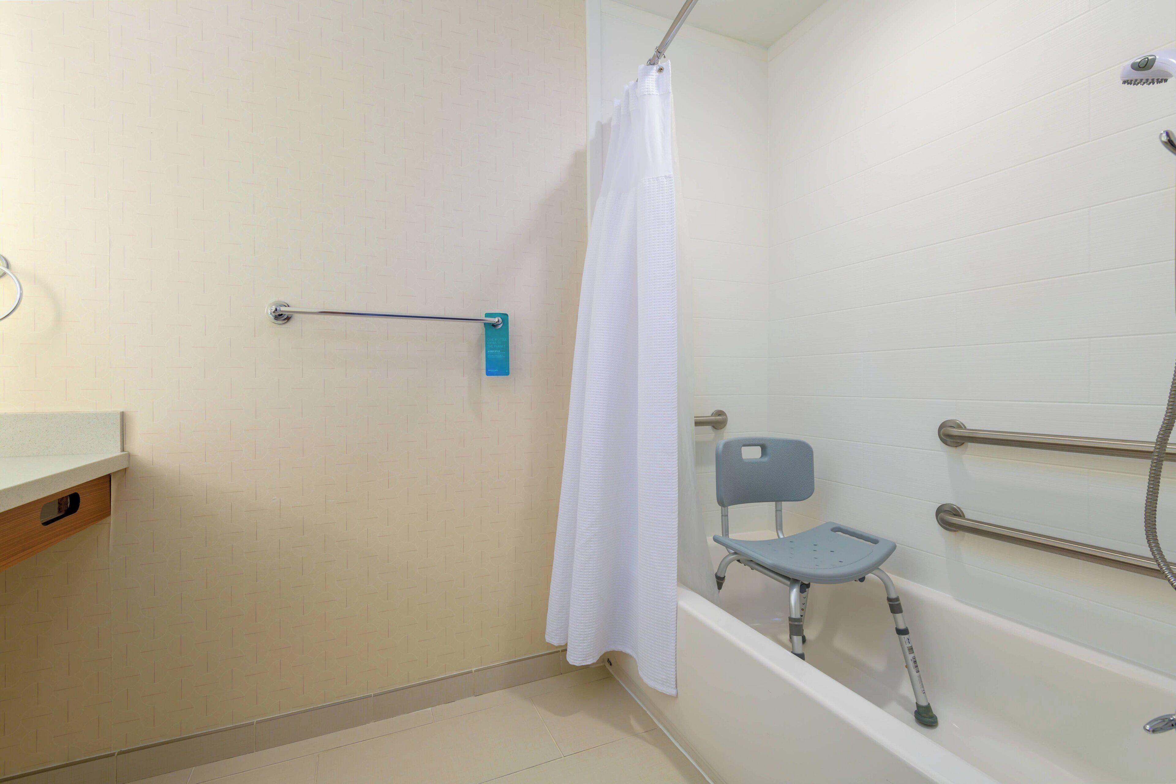 combined shower/bathtub, designer toiletries, hair dryer, towels