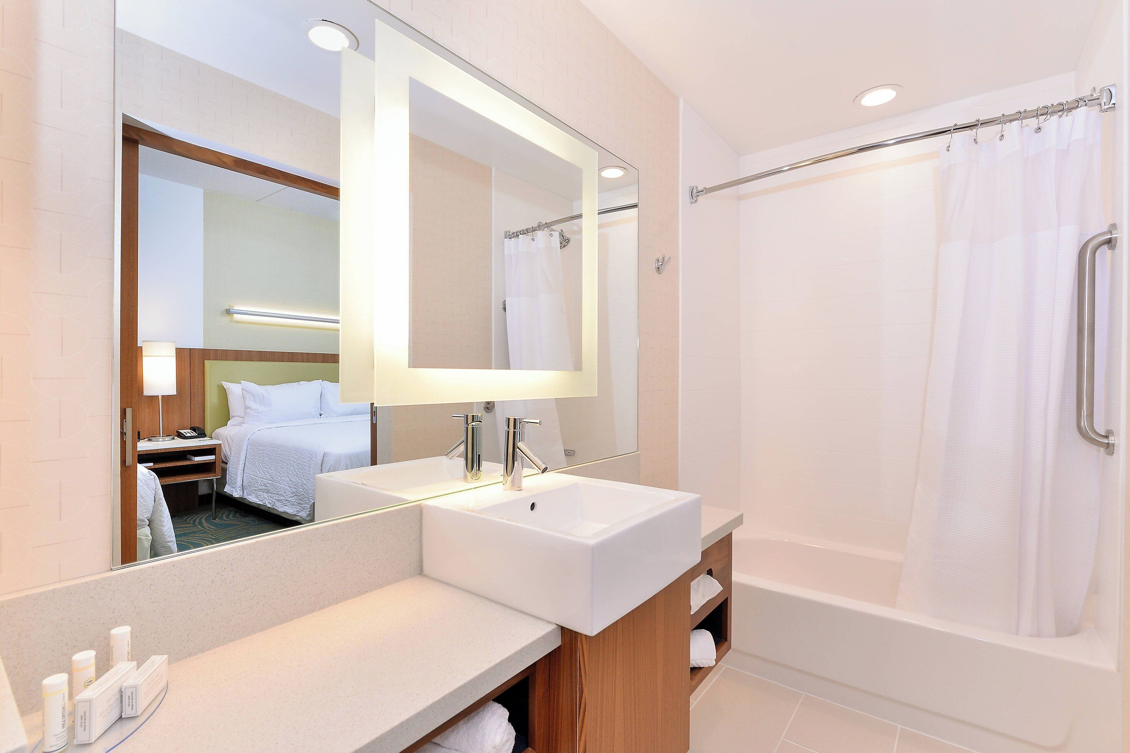 combined shower/bathtub, designer toiletries, hair dryer, towels