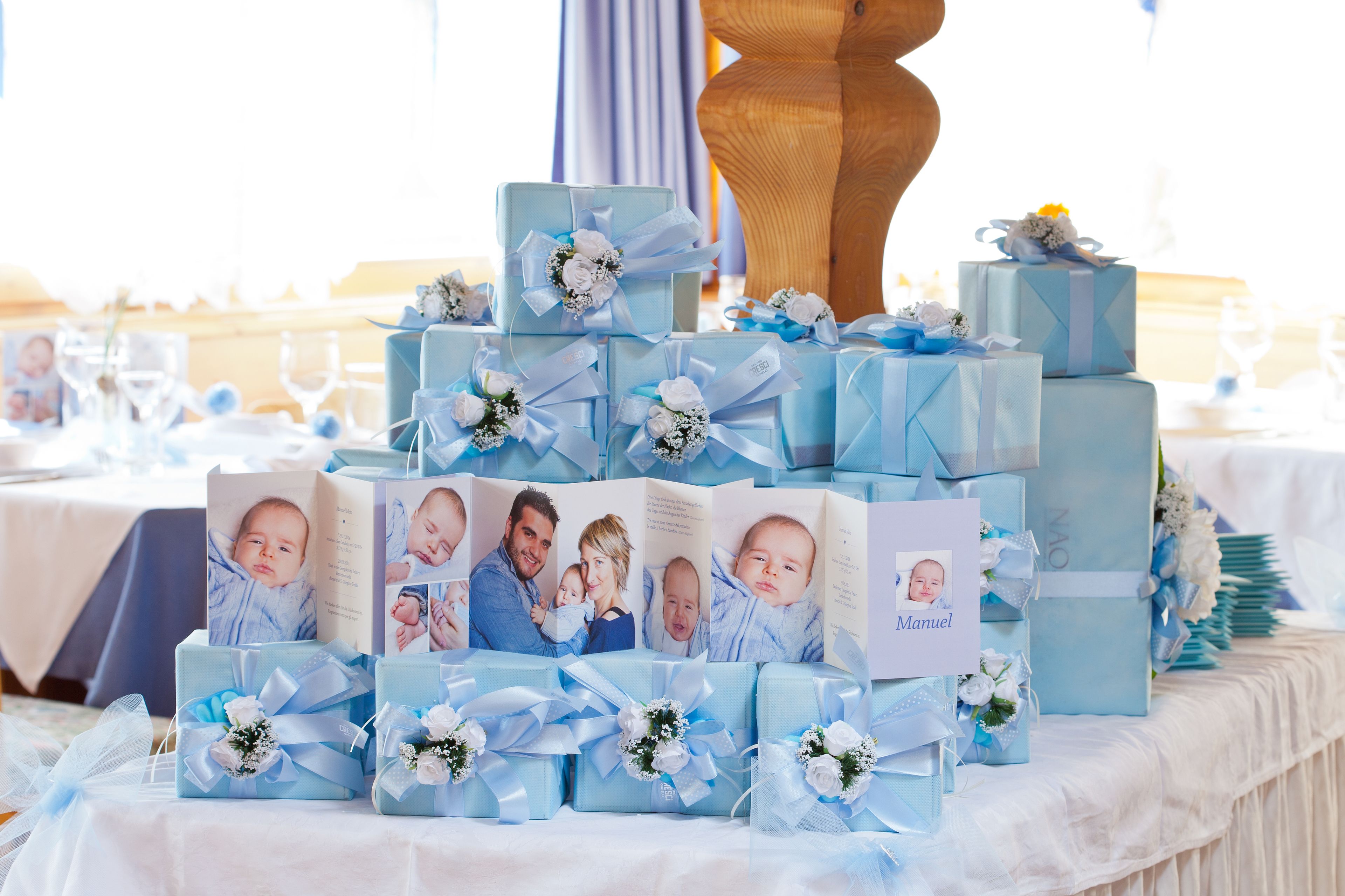 A table with multiple gift boxes and a photo album.