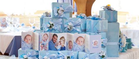 A table with multiple gift boxes and a photo album.