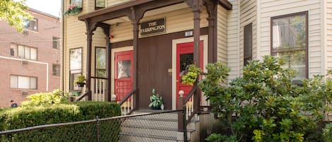 Un bâtiment à deux étages avec une porte rouge et une enseigne sur laquelle on peut lire « The Farrington ».