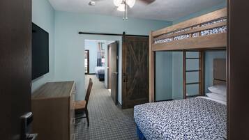 A bedroom with a bunk bed, a desk, and a chair.
