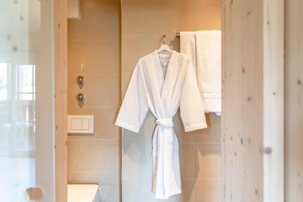 luxury studio suite | bathroom | shower, free toiletries, hair dryer, slippers