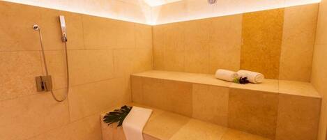 A modern bathroom with a bathtub, shower, and a towel rack.