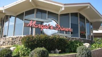 A building with a sign that reads "Morgie's Diner" and a large glass window.