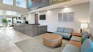 A modern hotel lobby with a reception desk, seating area, and large windows. - Best Western Plus Black Oak (Paso Robles)