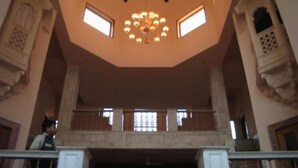 A spacious hall with a high ceiling, a central chandelier, and a balcony with railings. - Ananda Krishna Van (Mathura)