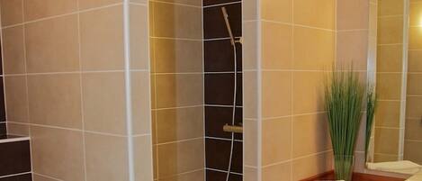 A modern bathroom with a shower, toilet, and vanity.
