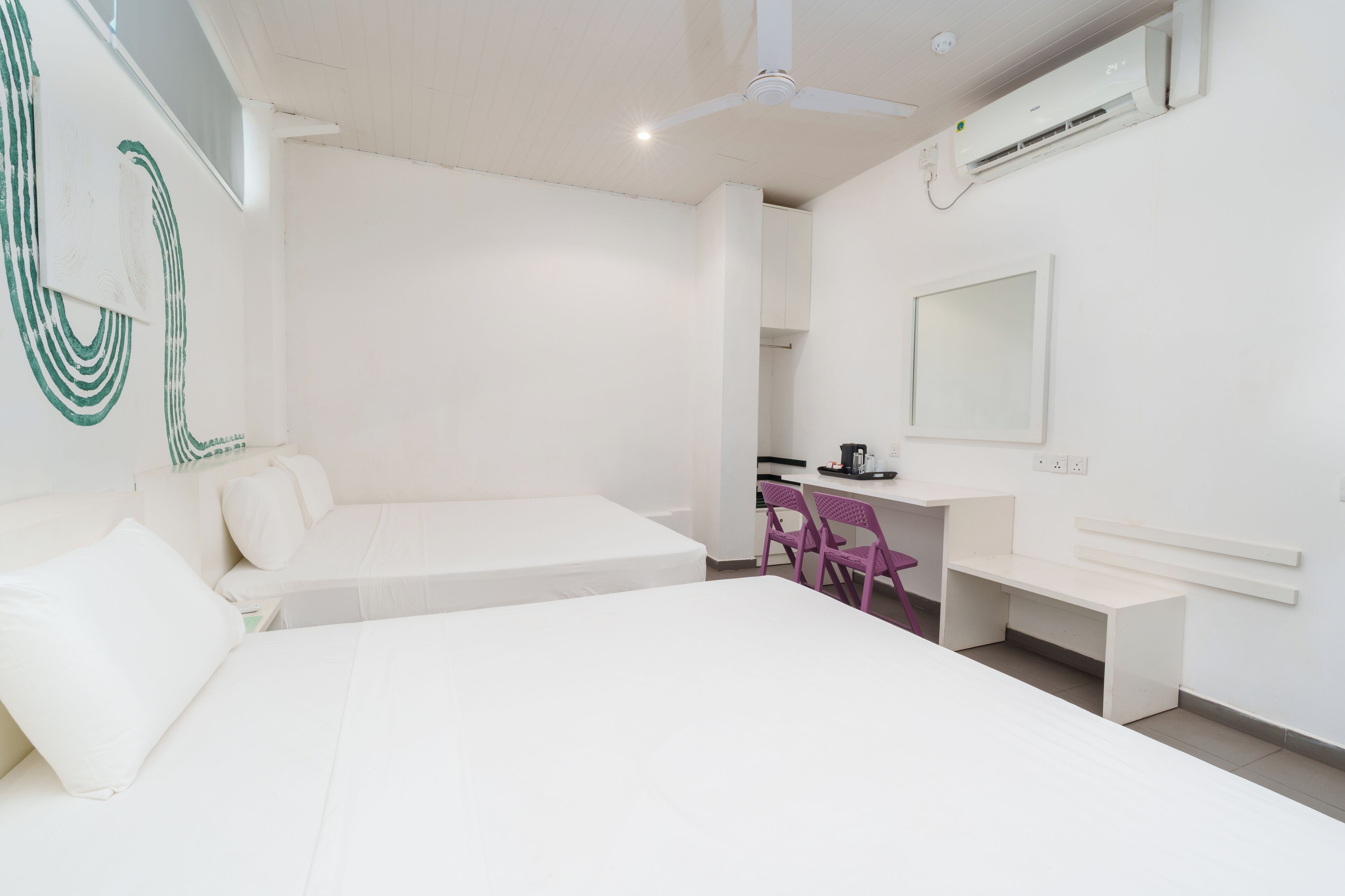 A modern, minimalist bedroom with a bed, a desk, and a chair.