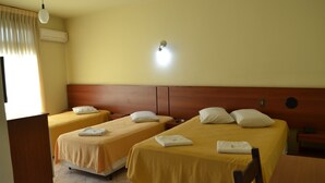 A hotel room with two single beds, a wooden headboard, a desk, and a chair. - Hotel Scala (Porto Alegre)