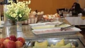 A buffet with various food items including fruits, vegetables, and bread. - Hotel Scala (Porto Alegre)