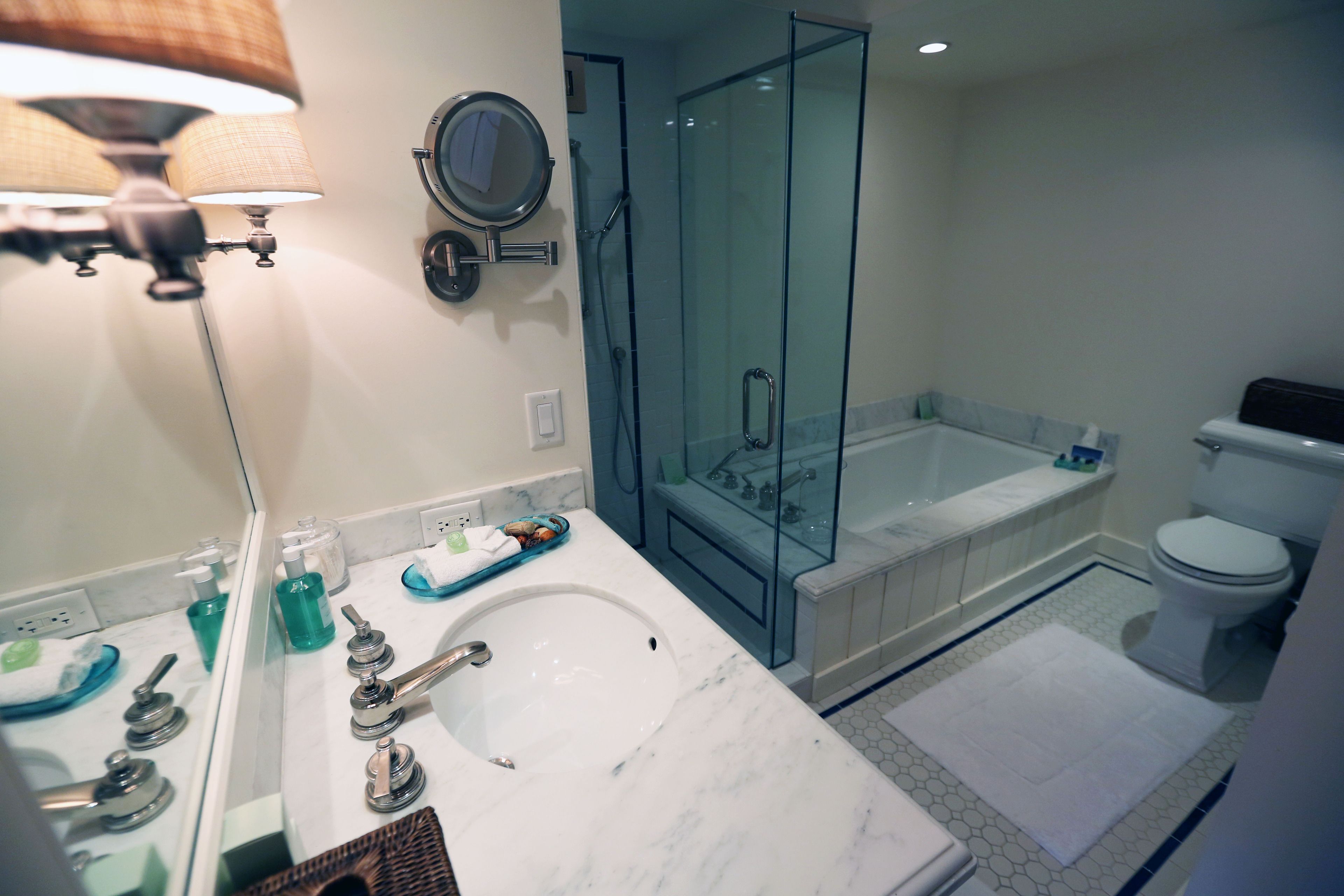 combined shower/bathtub, designer toiletries, hair dryer, towels