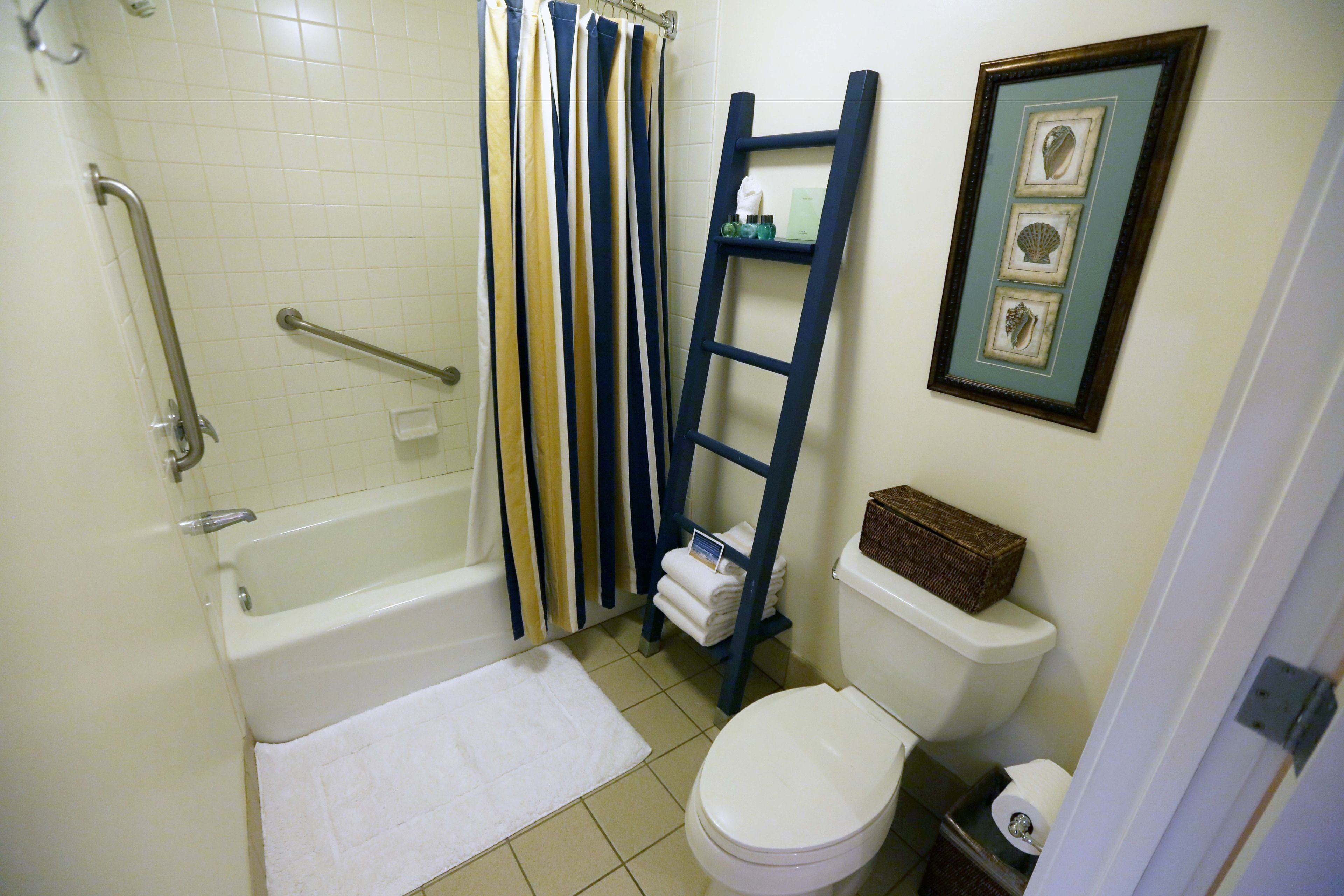 combined shower/bathtub, designer toiletries, hair dryer, towels
