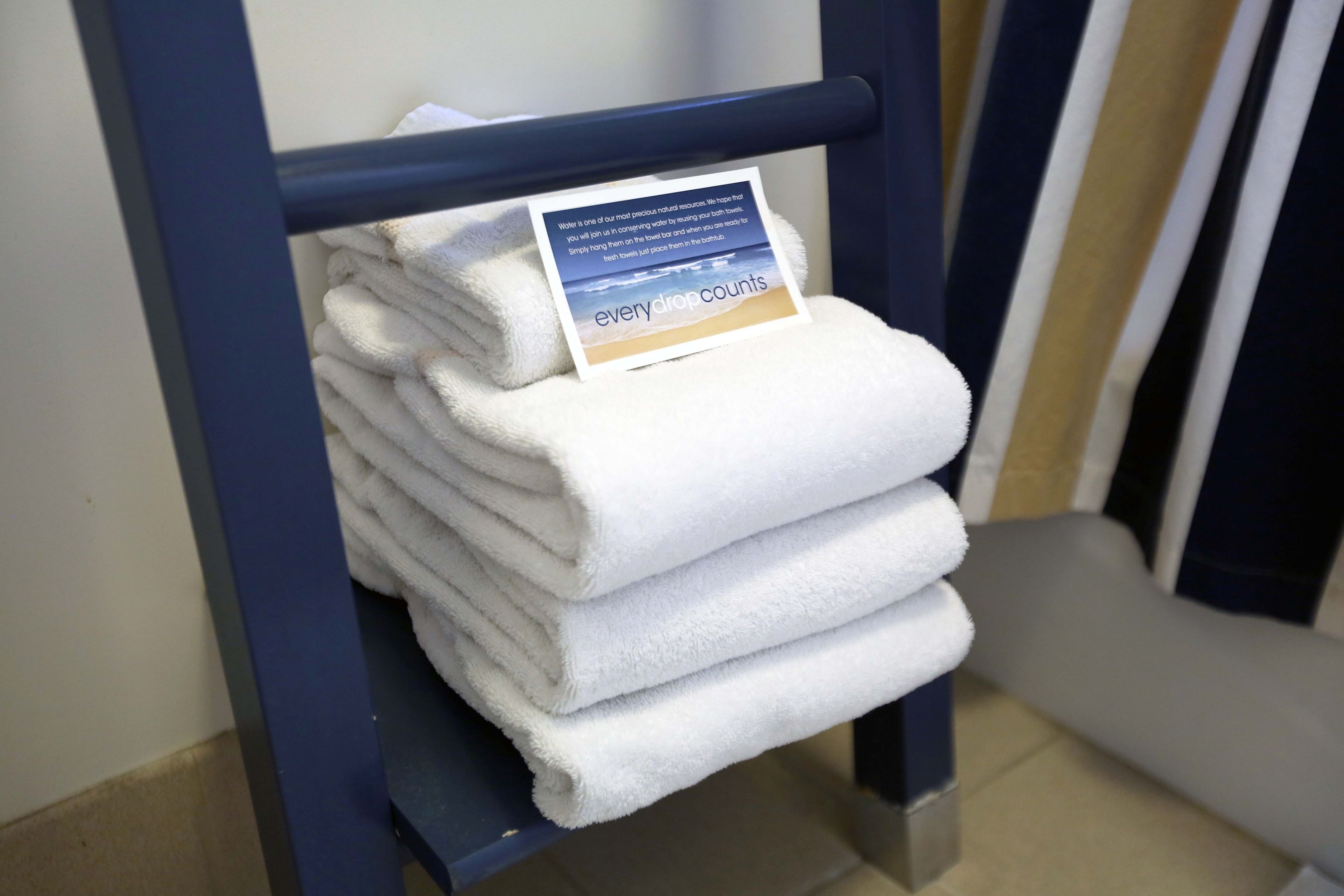 combined shower/bathtub, designer toiletries, hair dryer, towels