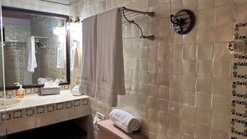A bathroom with a toilet, sink, and mirror.
