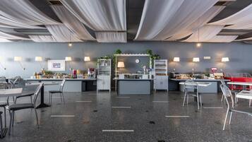 A modern restaurant with a central bar area, seating arrangements, and ambient lighting.
