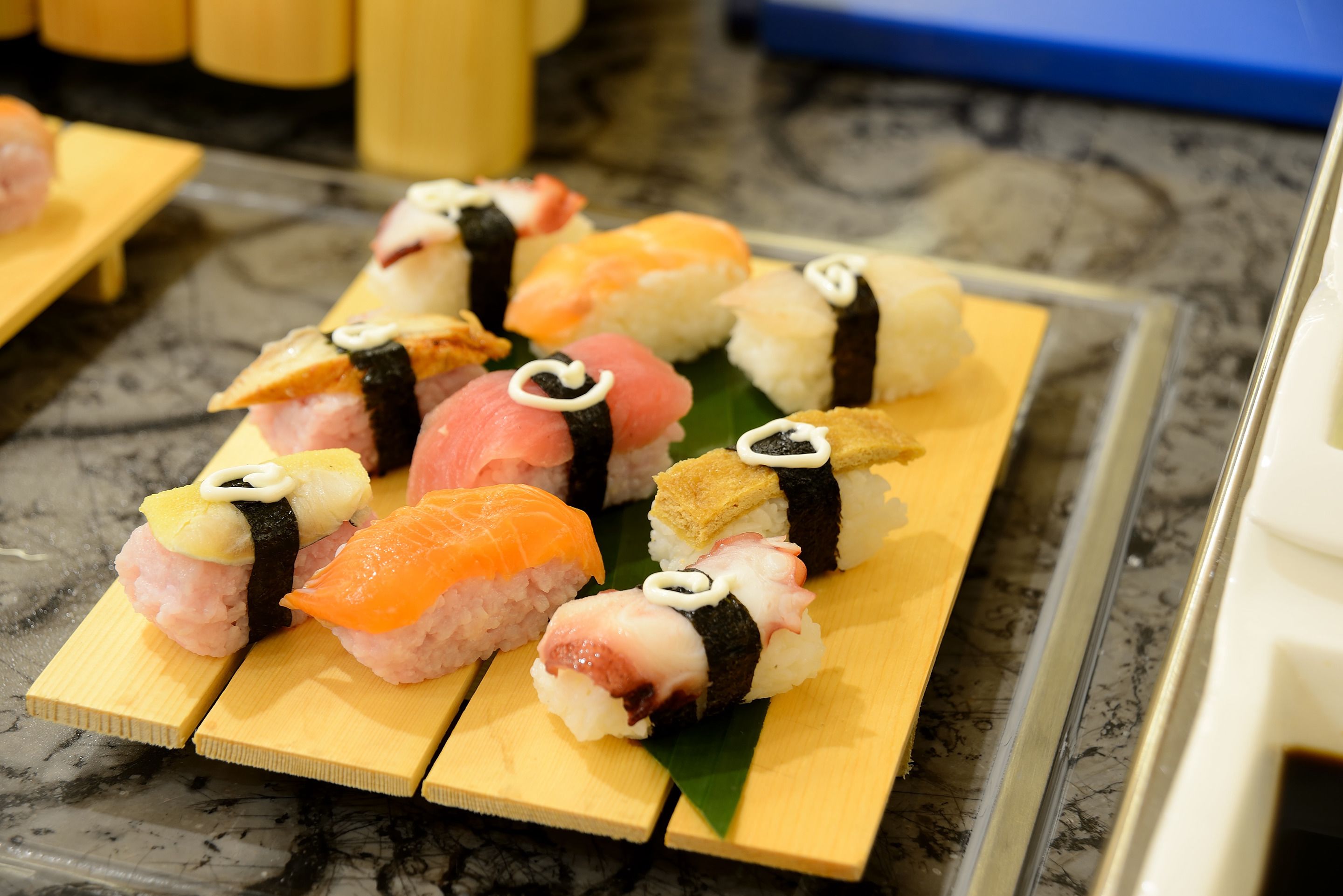 A selection of sushi on wooden trays.