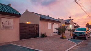 Un immobile residenziale con vialetto lastricato, cancello automatico e un'auto parcheggiata.