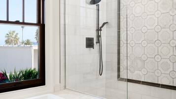 Shower, designer toiletries, hair dryer, towels