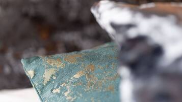 A close-up of a fabric with a distressed texture and a faded pattern.