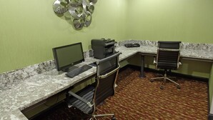 A hotel workspace with a desktop computer, printer, and office chair. - Comfort Inn & Suites West Artesia (Artesia)