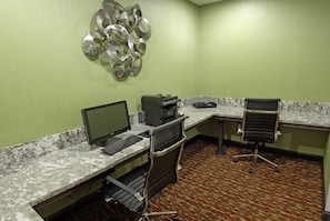 A hotel workspace with a desktop computer, printer, and office chair. - Comfort Inn & Suites West Artesia (Artesia)