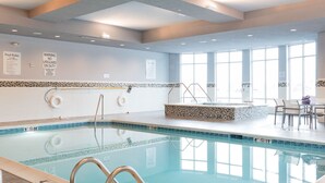 An indoor swimming pool with clear pool rules and a lifeguard on duty sign. - Holiday Inn Hotel & Suites Davenport by IHG (Davenport)