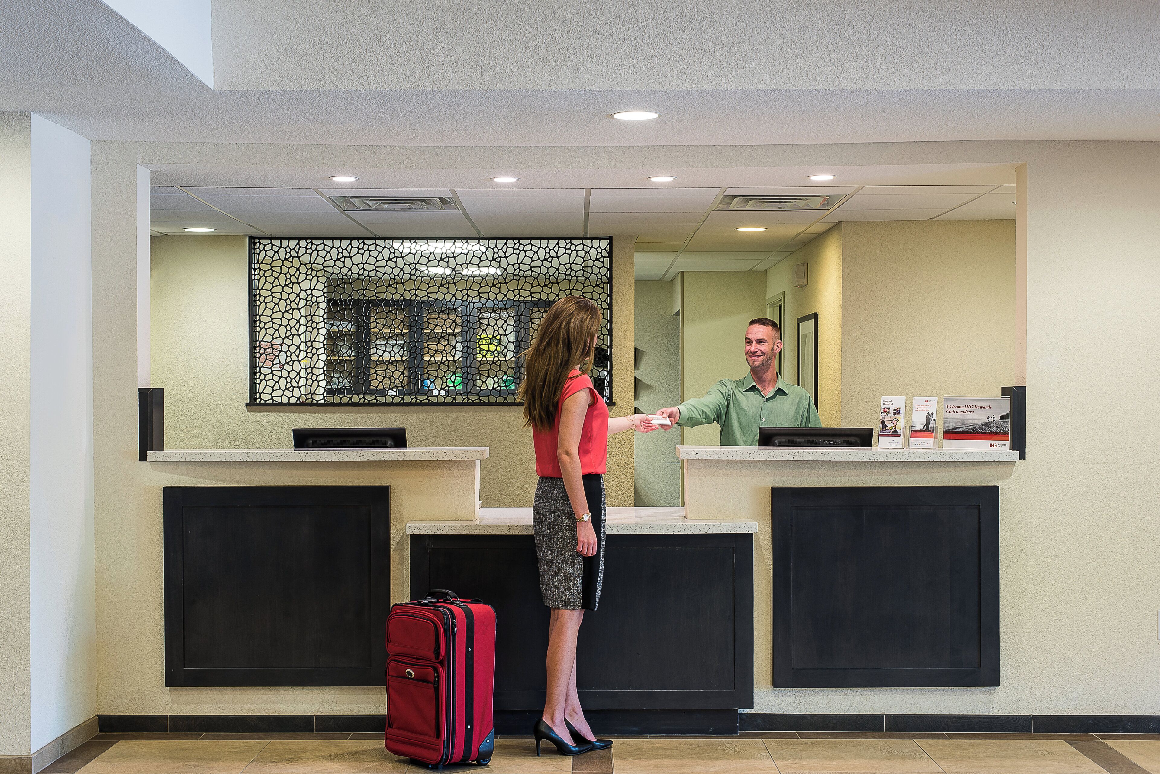 A reception desk with a check-in counter, a waiting area, and a reception desk with a computer.