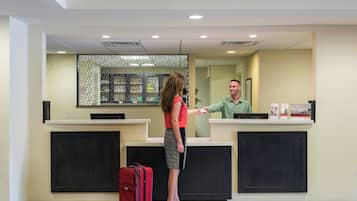 A reception desk with a check-in counter, a waiting area, and a reception desk with a computer.